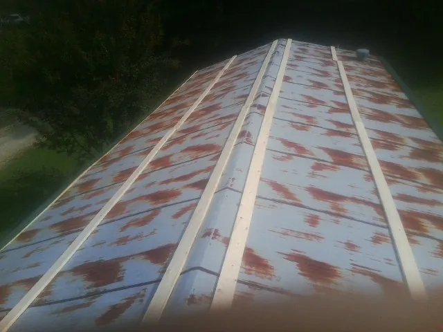 Rusted metal roof panels with new wood purlins before replacement — Storm Damage Roof Repair in Lake Toxaway by Roofing Brothers